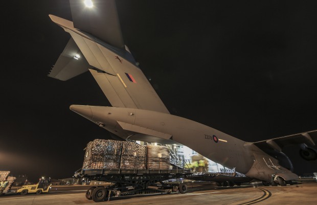 UK Aid being loaded onto an RAF C-17 Aircraft at RAF Brize Norton in Oxfordshire on the 15-March 2015 where it will be taken to the worst affected areas of Cyclone Pam in the south Pacific. Britain has sent vital shelter and relief supplies to help people whose lives have been devastated by Cyclone Pam, International Development Secretary Justine Greening announced. A Royal Air Force C-17 transport plane departed from RAF Brize Norton early on Monday 16 March and will travel to the Royal Australian Air Force base at Amberley in Australia, where it will join the international relief effort. The plane is carrying 1,640 shelter kits for use by families of five people and more than 1900 solar lanterns with inbuilt mobile phone chargers. These supplies will help to provide protection to some of the most vulnerable people affected by the cyclone, especially women and children. A humanitarian expert from the Department for International Development has also been deployed to advise on distribution of the supplies and assist with field assessments as part of the international relief effort. The C-17 and its crew will remain in Australia for several days to undertake further support flights between Australia and affected areas as required. [Picture: Crown Copyright] 