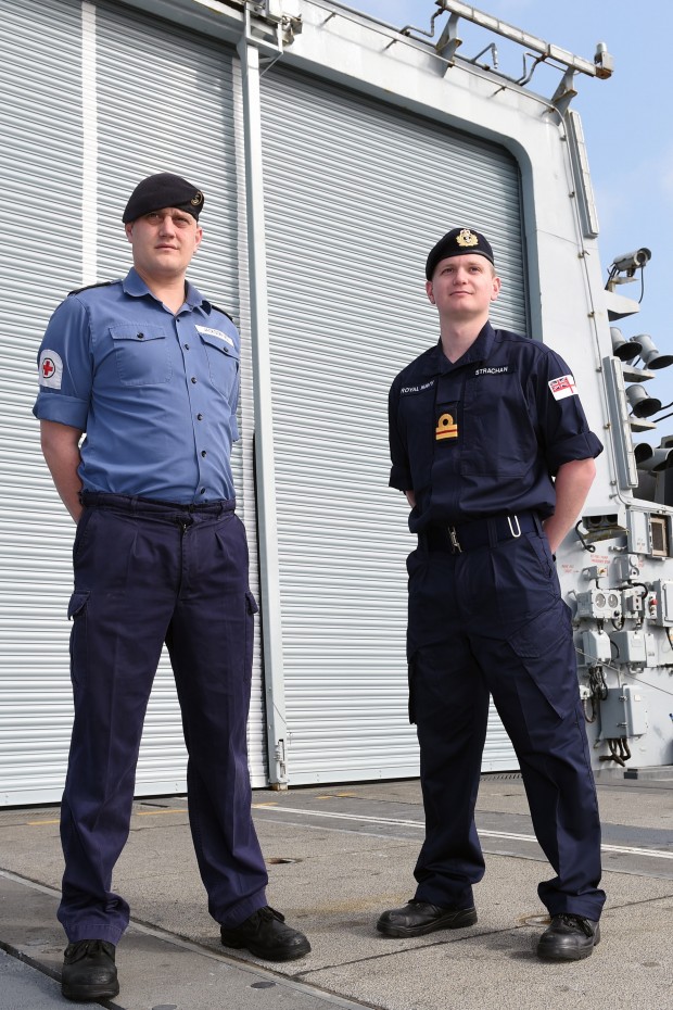Sailors on board HMS Lancaster will wear the Royal Navy’s first new uniform in 70 years when their ship leaves for a nine-month Atlantic patrol on Saturday. Replacing the Action Working Dress known as No4s – the traditional lighter-blue shirt and trousers worn by sailors at sea – it is the first major change to naval dress since the Second World War. HMS Lancaster’s sailors are the first ship to wear the clothing which is now dark blue and more modern, comfortable and fire retardant. It can be adapted to different climates, will offer more protection from flash fires and is designed to address corporate image with more Royal Navy branding, notably a large White Ensign on the left shoulder. Badges denoting rank will also be worn at the front rather than on the shoulders. Pictured Left to Right: Able Rating Jackson (old uniform) and LT Strachan (new uniform) on board HMS LANCASTER, 19 March 2015. [Picture: Crown Copyright] 