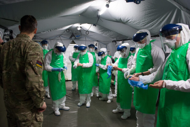 Medics are given a brief on correct use of Personal Protective Equipment. 