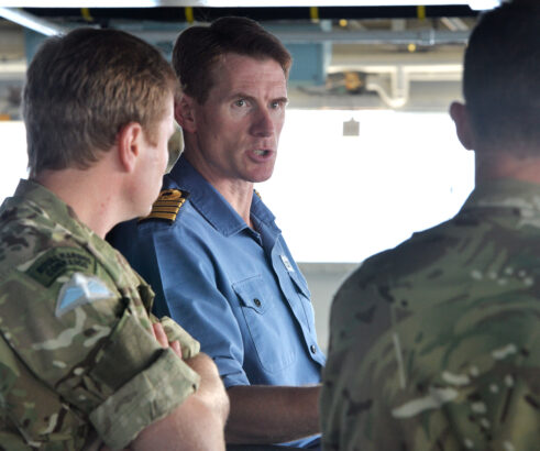 Commanding Officer, Captain Nick Cooke-Priest RN on the bridge of HMS Bulwark. HMS Bulwark is preparing for survivors to come on-board for OP Weald, this is a Safety of life at sea mission. The rescue is taking place in-between Italy and North Africa. Two Merlin Mk2 helicopters of 814 Naval Air Squadron, currently based at Sigonella air base near Catania, conduct landing, take-off, refuelling, winching and communications training with HMS Bulwark off the coast of Sicily. Once training with the amphibious assault ship, the helicopters will fly daily search and rescue missions over the Mediterranean as part of Operation Weald, Britains involvement in the international effort to help migrants crossing from North Africa to Europe. For more information please contact the Mod Press Office on 02072 182165 www.facebook/royalnavy Twitter: @royalnavy