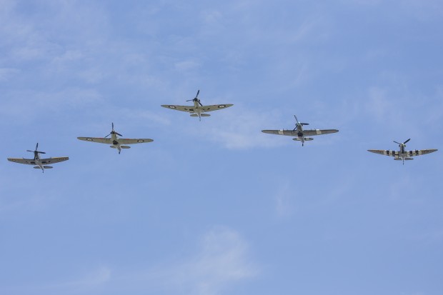 Pictured: Spitfires and Hurricanes form the Battle of Britain Memorial flight flying over Buckingham Palace. 75 years after the start of the Battle of Britain, the RAF marked the anniversary [Friday, 10 July] with an enhanced Change of the Guard and a flypast in front of The Queen and six Battle of Britain veterans at Buckingham Palace. After the Guard Mounting by the Queens Colour Squadron  the first time the RAF has mounted consecutive Queens Guards  Her Majesty and other members of the Royal Family watched a flypast of four Spitfires, two Hurricanes and four Typhoon jets, showcasing the RAF aircraft protecting UK skies then and now. 