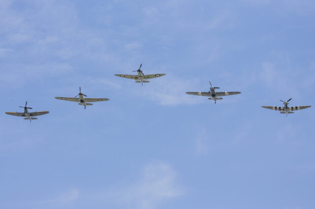 Pictured: Spitfires and Hurricanes form the Battle of Britain Memorial flight flying over Buckingham Palace. 75 years after the start of the Battle of Britain, the RAF marked the anniversary [Friday, 10 July] with an enhanced Change of the Guard and a flypast in front of The Queen and six Battle of Britain veterans at Buckingham Palace. After the Guard Mounting by the Queens Colour Squadron  the first time the RAF has mounted consecutive Queens Guards  Her Majesty and other members of the Royal Family watched a flypast of four Spitfires, two Hurricanes and four Typhoon jets, showcasing the RAF aircraft protecting UK skies then and now. 