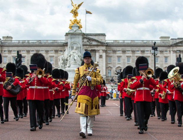 Senior Drum Major Household Division, WO2 Scott Fitzgerald, leads the Band of the Grenadier Guards down The Mall.   Today is HRH Prince GeorgeÕs 2nd birthday.  In celebration, the Band of the Grenadier Guards played ÒHappy BirthdayÓ during the ceremony of Changing of the Guard at Buckingham Palace, to the delight of the thousands of tourists that had gathered outside the Palace gates.   Undertaken by one of the five regiments of the Foot Guards, Changing the Guard or ÔGuard MountingÕ is the process by which the new Guard exchanges duty with the old at the Royal Palaces.  It is watched by millions of visitors to the capital, daily in Summer and every other day during the rest of the year.  The handover ceremony is accompanied by one of the five bands of the Foot Guards, who play traditional military marches, music from films and musicals, well-known pop songs, or as today, celebratory tunes.