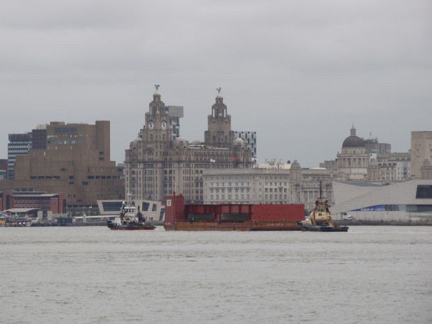 The Prince of Wales Carrier travelling past the Royal Liver Building on the River Mersey 