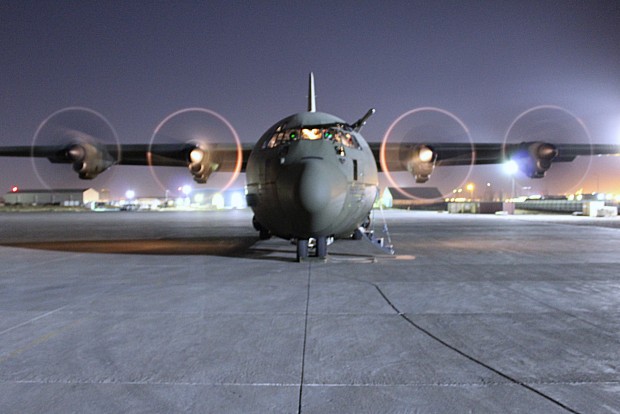 An RAF C-130J Hercules air transport aircraft parked at Erbil, North Iraq, after delivering passengers and freight in its role flying the Op SHADER Air Bridge. The aircraft was photographed on start up, shortly before it departed for its flight back to RAF Akrotiri, Cyprus