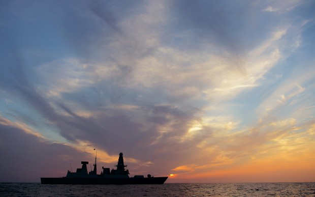 HMS Dragon crossing the setting sun