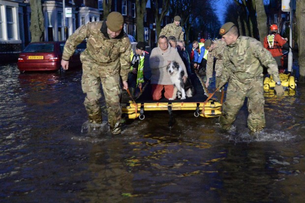 Soldiers from 1st Battalion The Duke of Lancaster's Regiment help evacuate residents