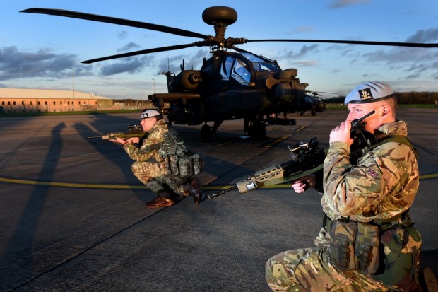 Pictured are two members of the Military Provost Guard Service (MPGS) guarding Apache Helicopters at the Army Aviation Centre at Middle Wallop. Crown Copyright
