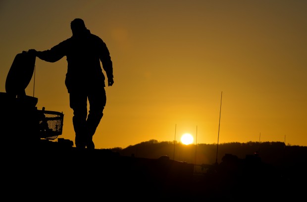 A soldier is silhouetted on the top of his armoured vehicle by the rising sun. The British Armys Wiltshire based 3rd (UK) Division is holding Exercise Tractable 2016 on Salisbury Plain Training Area this month. The exercise is designed to test the ability the Divisions Lead Armoured Task Force (LATF) to deploy from barracks via a centralised Staging Area or Mounting Centre, to air and sea points of embarkation. It will see the movement of more than 1,800 personnel and 1,200 vehicles, including Challenger 2 main battle tanks and is part of a series of annual exercises intended to prove the readiness of the British Armys main intervention capability Division.