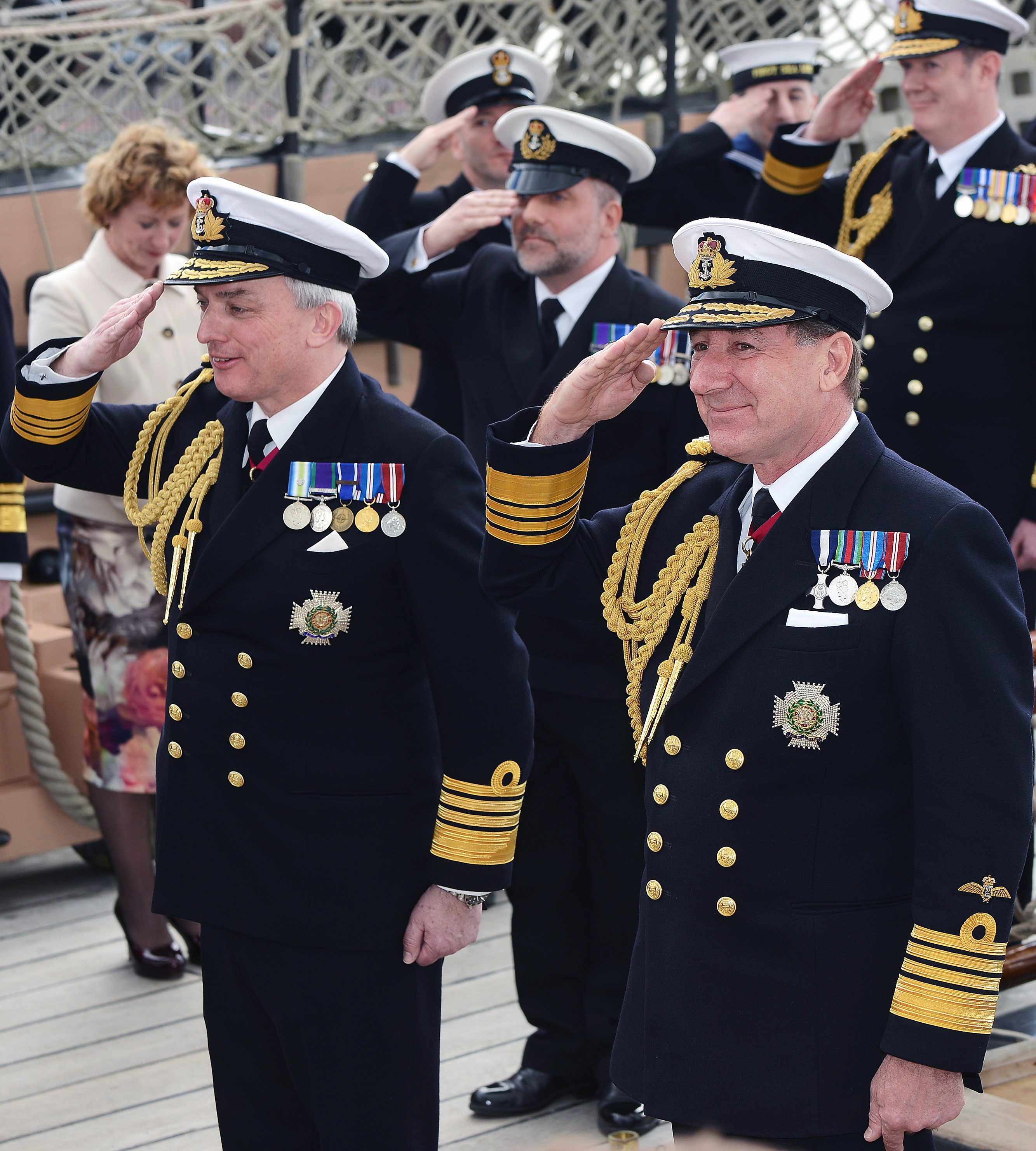 ADMIRAL SIR PHILIP JONES REFLECTS ON NAVY’S BRIGHT FUTURE AS HE TAKES OVER AS FIRST SEA LORD FROM ADMIRAL SIR GEORGE ZAMBELLAS Pictured - Admiral Sir George Zambellas right and Admiral Sir Philip Jones. The torch of Naval leadership today [Friday April 8] changed hands as Admiral Sir Philip Jones took over as Britain’s senior sailor and his predecessor, Admiral Sir George Zambellas, stepped down after 35 years’ serving his nation. In the great cabin of the world’s oldest commissioned warship, HMS Victory, Admiral Zambellas formally handed over command of more than 30,000 men and women, nearly 90 warships, nuclear submarines and support vessels, the helicopters and jets of the Fleet Air Arm and the elite Naval infantry of the Royal Marines to the man who has overseen the day-to-day operations of the Royal Navy since 2013 as its Fleet Commander. During his three-year spell in charge, Admiral Jones will oversee the aircraft carrier HMS Queen Elizabeth’s entry into service. Her sister ship, HMS Prince of Wales, will begin sea trials and the world’s most advanced fifth generation jet aircraft, the F-35B Joint Strike Fighter, will operate from a Royal Navy ship for the first time.