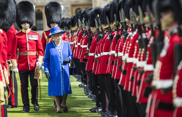 Pictured is The Queen, Colonel-in-Chief of 1st Battalion Welsh Guards. She is presenting new Colours to the Regiment at Windsor. This is the eighth set of Colours that have been presented to the 1st Battalion Welsh Guards in their 100 year history. Colours are the Regimental Flags of the British Army. They were originally used as rallying points on the battlefield as long ago as the Kings of Babylon. They were vital because before modern communications, it was all too easy for troops to become disorientated by the fog of war. From the reign of Queen Anne every regiment has been awarded two colours: the Queens Colour and the Regimental Colour. In the Guards Regiments the Queens Colour is crimson silk and the Regimental Colour is the Union Flag.