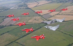 Air power: Jets from the Royal Air Force Aerobatic Team, the Red Arrows, seen in formation with two Typhoons and the F-35B Lightning II. The special formation took place at the Royal International Air Tattoo, Gloucestershire, and marked the arrival into the UK of the F-35B in June.