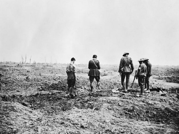A chaplain of the Royal Army Chaplains' Department (RAChD) conducting a burial service near the trenches near Guillemont, September 1916.