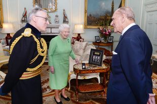 Queen Elizabeth II with the Duke of Edinburgh talk with Lieutenant Geneneral Richard Nugee, as he presents them both with long service and good conduct medals from the armed forces, during a private audience at Buckingham Palace in central London. PRESS ASSOCIATION Photo. Picture date: Tuesday October 11, 2016. Photo credit should read: John Stillwell/PA Wire