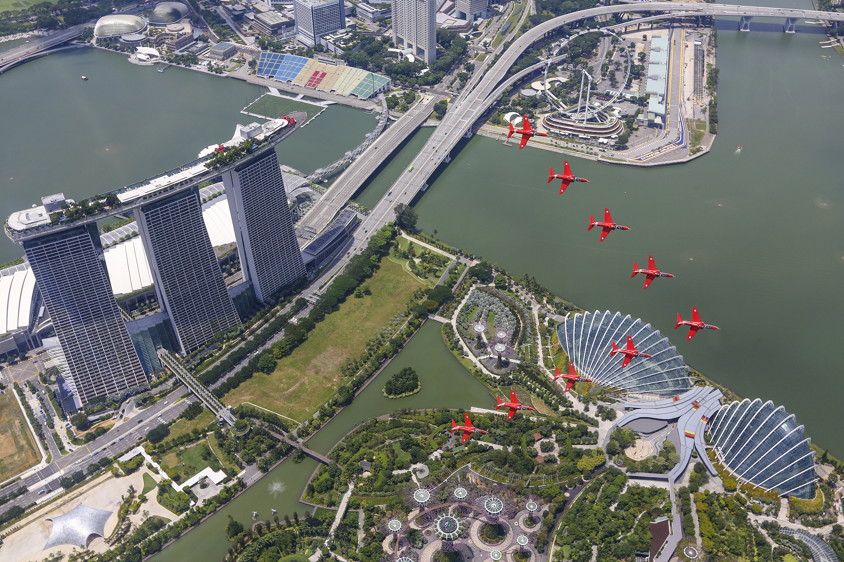 18 Oct 2016 RAF Red Arrows perform flypast over Singapore Jets from the Royal Air Force Aerobatic Team, the Red Arrows, carried out a spectacular flypast over Singapore toady (October 18). The Red Arrows flew over a stunning backdrop in the Lion City, including Marina Bay Sands and Gardens by the Bay. The performance by the world-renowned display team was part of a 60-day tour of the Asia-Pacific and Middle East regions, supporting UK interests and raising awareness of British innovation, industry and engineering excellence. After the flypast, the Red Arrows British-built Hawk jets landed at Paya Lebar in Singapore, where the crews met military, business and other leaders. A few days before the flypast, a Red Arrows advance team had carried out a visit to a local university and also Rolls-Royces Seletar Campus, to promote the importance of the so-called STEM subjects of science, technology, engineering and maths. Squadron Leader David Montenegro, Team Leader of the Red Arrows and who leads the nine-jet formation as Red 1, said: The Red Arrows are thrilled to be able to perform in such a vibrant location as Singapore and are grateful for the support provided by the authorities and Republic of Singapore Air Force to make it possible. The flypast was a unique, high-profile and tangible way of demonstrating the UKs long-standing relationship with Singapore. Were delighted to be able to support British industries and businesses in such an exciting way in Singapore and the event illustrates how Britain is global, working with partners across the world. Together with the associated ground activities during our visit  highlighting engineering and aerospace excellence  I hope we have also inspired young people to study the important STEM subjects.      This image shows the Royal Air Force Aerobatic Team The Red Arrows arriving in Singapore with a flypast over the marina area. Also in the shot is the Marina Bay Sands Hotel. Th