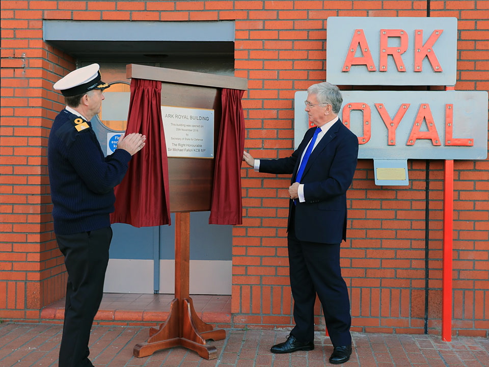 Defence Secretary, The Right Honourable Sir Micaheal Fallon (right) unveils the new plaque at Ark Royal Building in Portsmouth Naval Base with Commodore Jeremy Rigby (left). Defence Secretary Sir Michael Fallon visited Portsmouth today (25 Nov 2016) to view some of the final preparations for the arrival of HMS Queen Elizabeth. Sir Michael toured parts of HM Naval Base Portsmouth to see the progress of the latest work in preparation for the first of the largest warships ever built for the Royal Navy. The Defence Secretary also opened the new Ark Royal building on Princess Royal jetty, which has been set up in support of the new carriers.