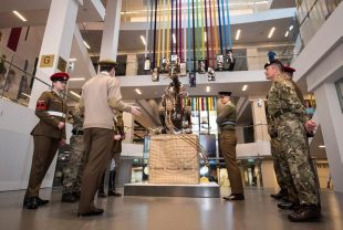 Soldiers look at the Rat Sculpture that is in the centre of the reopened National Army Museum.