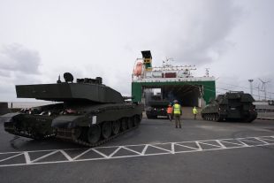 An AS90 and a Challenger 2 tank being loaded onto cargo ship in the port of Emden, Germany, before deployment to Estonia.