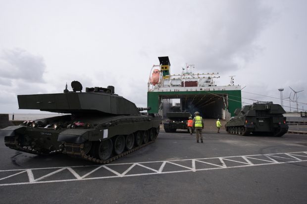 An AS90 and a Challenger 2 tank being loaded onto cargo ship in the port of Emden, Germany, before deployment to Estonia.