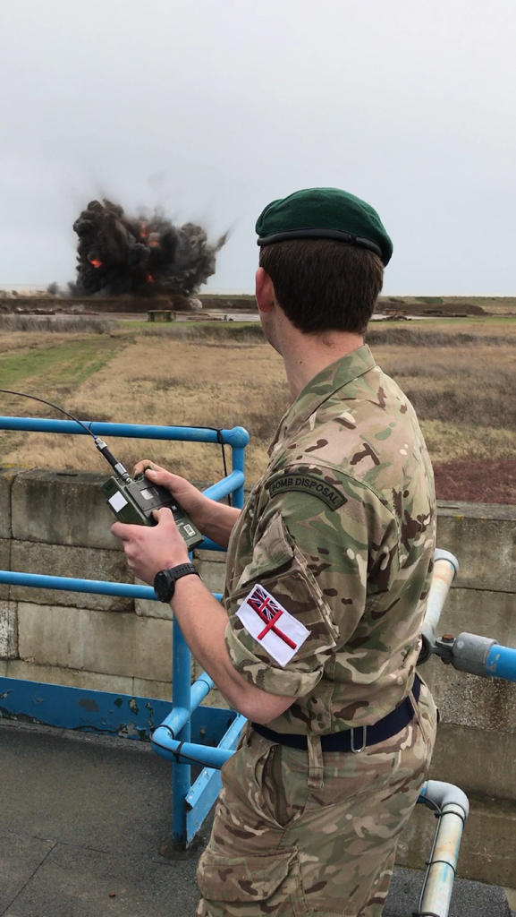 Image shows a Royal Navy Bomb Disposal expert, detonating the German WWII SC 500lb bomb. After a long, cold night of expert and cautious work at the Brondesbury Park building site near Brent, rendering the fuse safe on the German WW2 SC 500lb air dropped bomb yesterday, the Armys Royal Engineers were relieved to hand over the ultimate disposal of the 500lb explosive to a four-man Royal Navy Team from the SOUTHERN DIVING UNIT (2) based in Horsea Island, Portsmouth. The Royal Navy team made a controlled demolition of the WW2 ordnance at Shoeburyness Range near Southend, Essex at 1130am on Saturday morning (4 March 17). AB (Diver) Liam Boardman initiated the demolition of the bomb, supported by the Navys team of duty Mine Clearance Divers, led by Petty Officer Diver Craig Waghorn and including Leading Diver Matthew Smark and AB Diver Steve Lundsten who travelled up last night from their Hampshire base to assist the Army team.