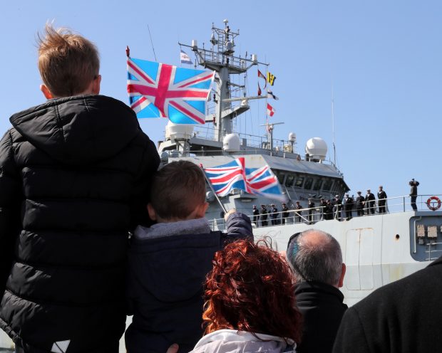 HMS Enterprise Returns Home to HMNB Devonport Image shows Thomas and James Wharton waving union jacks to welcome home thier Aunt Stephanie Merlo. Crown Copyright.