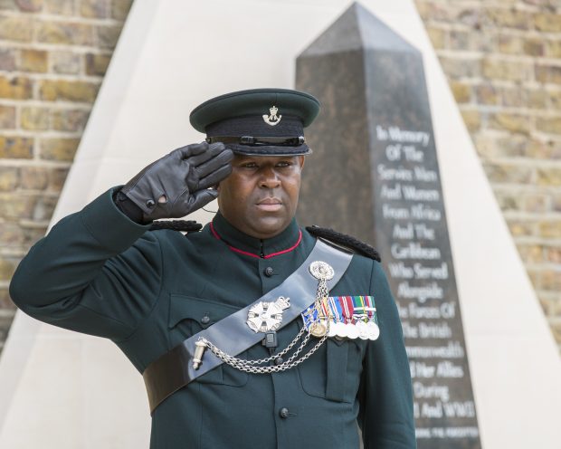 Major Larry Davis salutes as the Last Post is sounded after the unveiling of the African and Caribbean War Memorial in Windrush Square, Brixton.