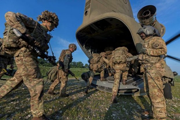 Grenadier Guards getting on a US Chinook helicopter during Exercise NOBLE JUMP taking place in Romania. The Defence Secretary will meet personnel involved in the NATO exercise on a visit to Romania today. Crown Copyright.