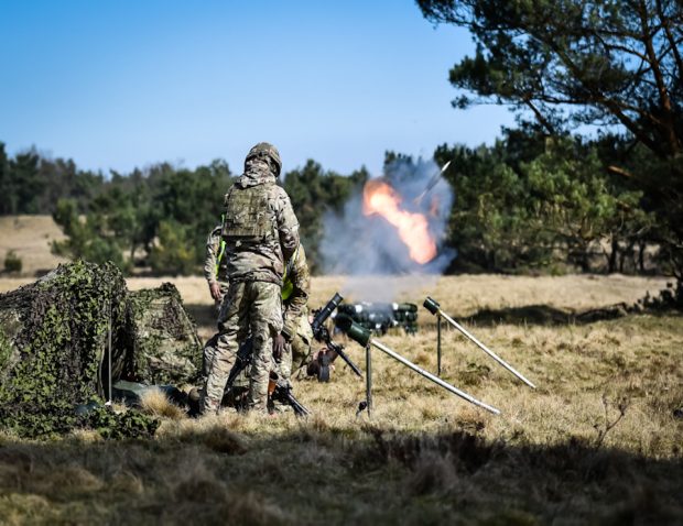 British Army Soldiers from 1st Battalion The Princess of Wales's Royal Regiment (1 PWRR), known as the Tigers, train new Mortar teams on a two-week exercise. A mortar round is visible in flight.