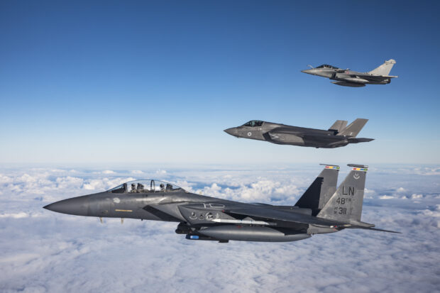 A USAF F-15E Strike Eagle, RAF F-35B Lightning and Armee de l'air Rafale flying in formation