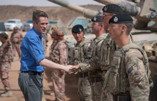 The Defence Secretary with soldiers from the Royal Tank Regiment