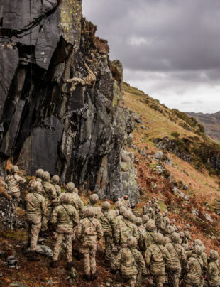 Royal Marines abseiling from a cliff