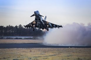 An RAF Lossiemouth Typhoon fighter jet takes off equipped with Meteor missiles. 