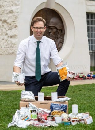 The Parliamentary Under Secretary of State and Minister for Defence with a ration box