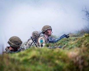 Paratroopers training on a grassy hill