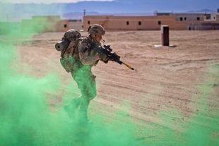 A British Royal Marine with 45 Commando assaults an objective.