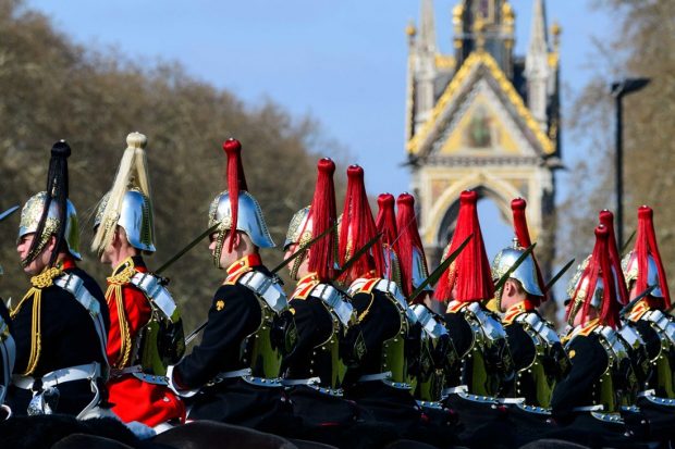 A row of Blues and Royals soldiers and officers on horseback in front of the Albert Memorial in Hyde Park.