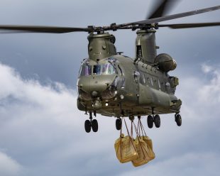 An RAF Chinook carrying bags of rubble to help flood defences