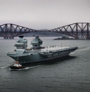 The HMS Prince of Wales sailing near the Forth Bridge