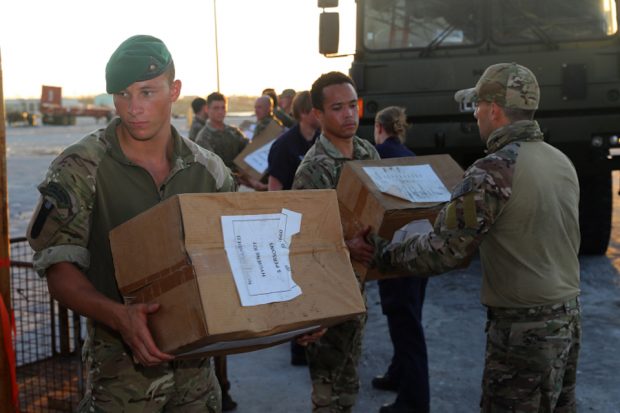 Royal Marines delivering boxes of aid